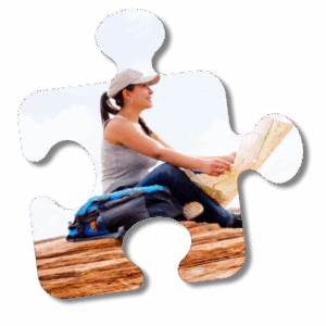 A puzzle piece element showing a woman sitting on a desert land holding a roadmap.